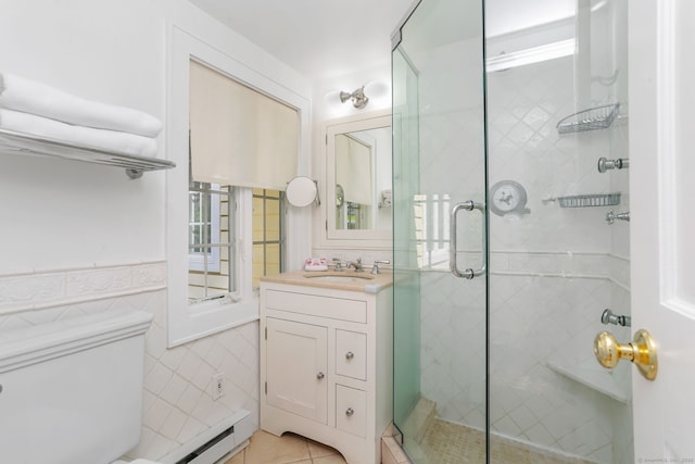 bathroom featuring vanity, toilet, tile walls, and a stall shower