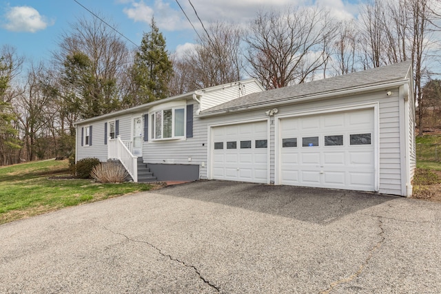 ranch-style home featuring an attached garage and driveway
