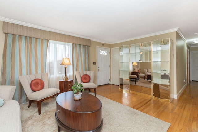 living room with light wood-type flooring, baseboards, and ornamental molding