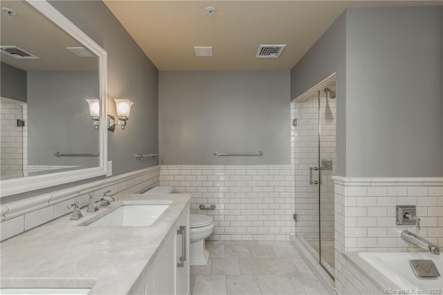85 Memorial Rd Apt 414, West Hartford, CT 06107 - full bath with a garden tub, a sink, a stall shower, tile walls, and visible vents