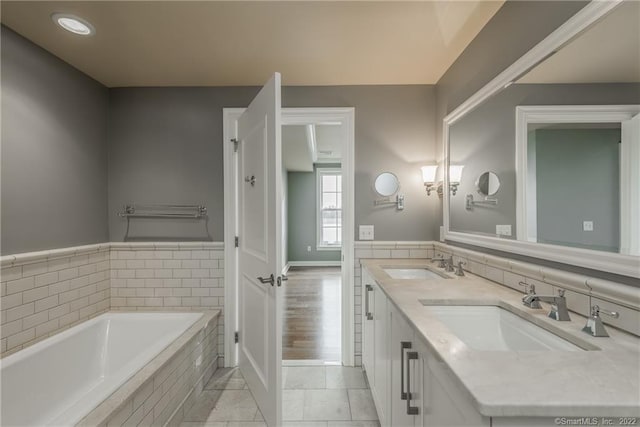 85 Memorial Rd Apt 414, West Hartford, CT 06107 - bathroom featuring double vanity, a garden tub, tile patterned floors, and a sink