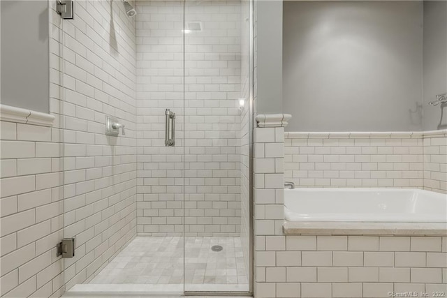 85 Memorial Rd Apt 414, West Hartford, CT 06107 - full bathroom featuring tile walls, a garden tub, and a stall shower