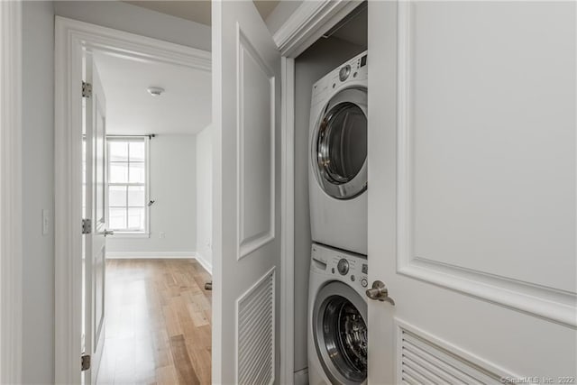 85 Memorial Rd Apt 414, West Hartford, CT 06107 - laundry area featuring wood finished floors, laundry area, stacked washer / drying machine, baseboards, and visible vents