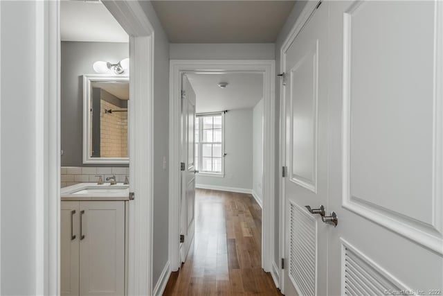 85 Memorial Rd Apt 414, West Hartford, CT 06107 - hall with visible vents, baseboards, a sink, and dark wood finished floors