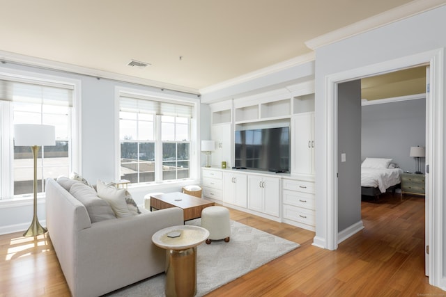 85 Memorial Rd Apt 414, West Hartford, CT 06107 - living room with baseboards, light wood-style flooring, visible vents, and crown molding