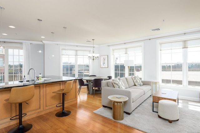 85 Memorial Rd Apt 414, West Hartford, CT 06107 - living room featuring recessed lighting, visible vents, light wood-type flooring, crown molding, and a chandelier