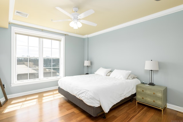 85 Memorial Rd Apt 414, West Hartford, CT 06107 - bedroom featuring baseboards, visible vents, a ceiling fan, wood finished floors, and crown molding