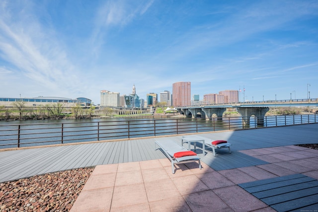 view of patio with a water view and a city view