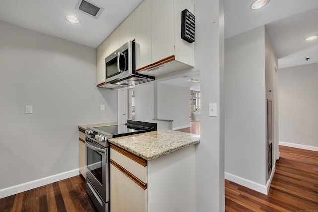 kitchen featuring dark wood-style floors, visible vents, appliances with stainless steel finishes, and baseboards