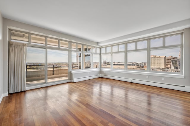 unfurnished sunroom featuring wood finished floors