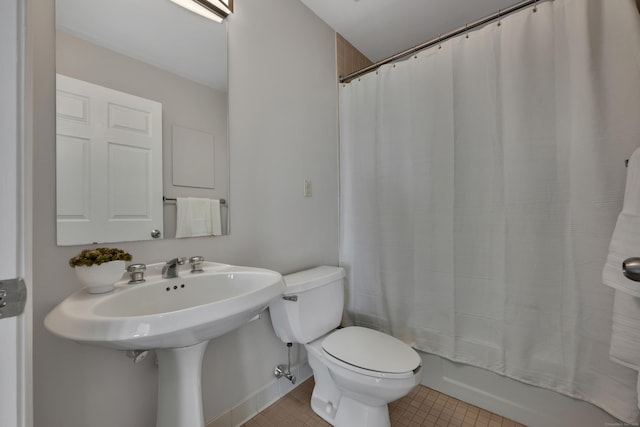bathroom featuring shower / tub combo with curtain, toilet, and tile patterned flooring