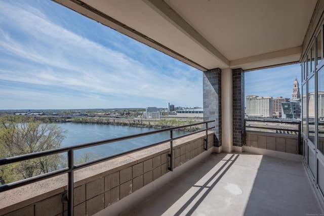 balcony with a view of city and a water view