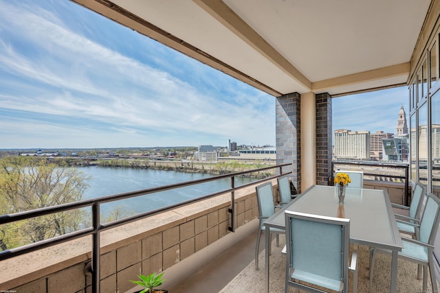 balcony with a view of city and a water view