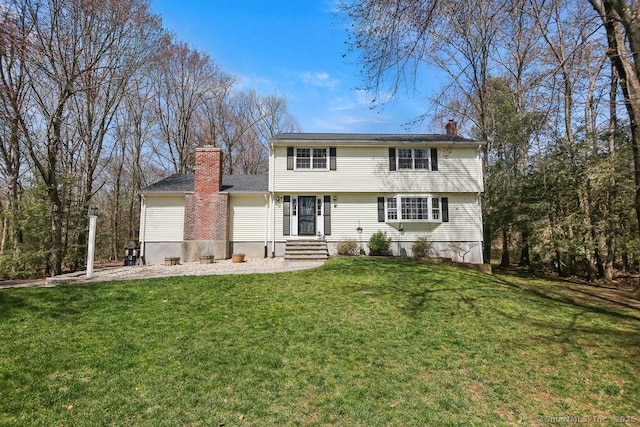 8 Gregory Ln, Simsbury, CT 06070 - colonial-style house featuring a front yard and a chimney