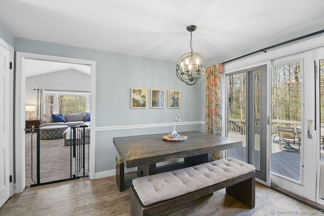 8 Gregory Ln, Simsbury, CT 06070 - dining space with wood finished floors, a notable chandelier, vaulted ceiling, and baseboards