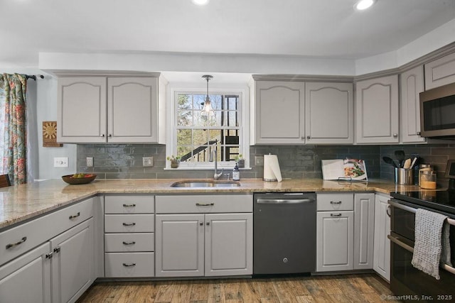 8 Gregory Ln, Simsbury, CT 06070 - kitchen featuring tasteful backsplash, light stone counters, appliances with stainless steel finishes, and a sink