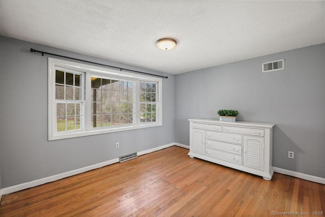 8 Gregory Ln, Simsbury, CT 06070 - unfurnished bedroom featuring visible vents, hardwood / wood-style floors, and multiple windows