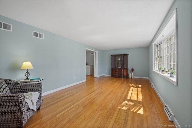 8 Gregory Ln, Simsbury, CT 06070 - living room featuring light wood finished floors, visible vents, and baseboards