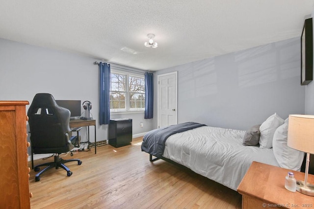 8 Gregory Ln, Simsbury, CT 06070 - bedroom featuring baseboards, wood finished floors, and a textured ceiling