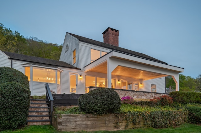 rear view of property with a chimney