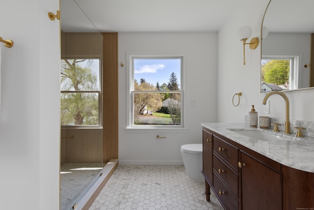 full bath featuring toilet, baseboards, a wealth of natural light, and vanity