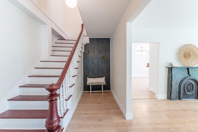 stairs with baseboards and wood finished floors