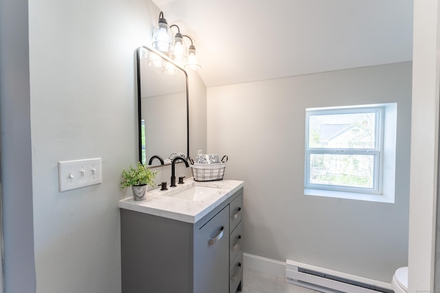 bathroom with vanity, toilet, baseboards, and a baseboard radiator