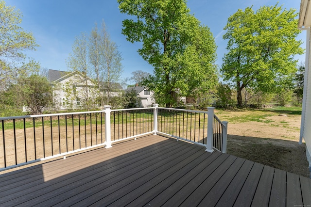 wooden terrace featuring a yard