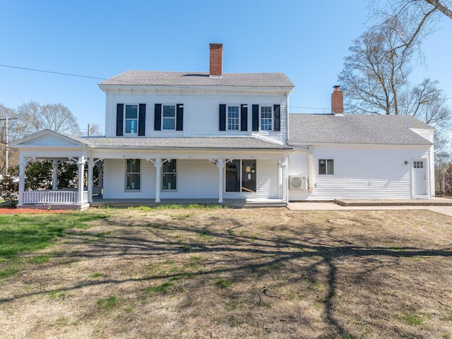 view of front of home with covered porch and a chimney