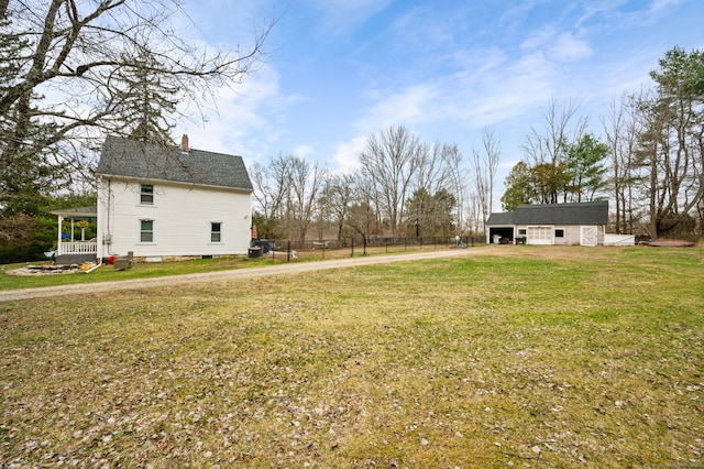 view of yard featuring driveway and fence