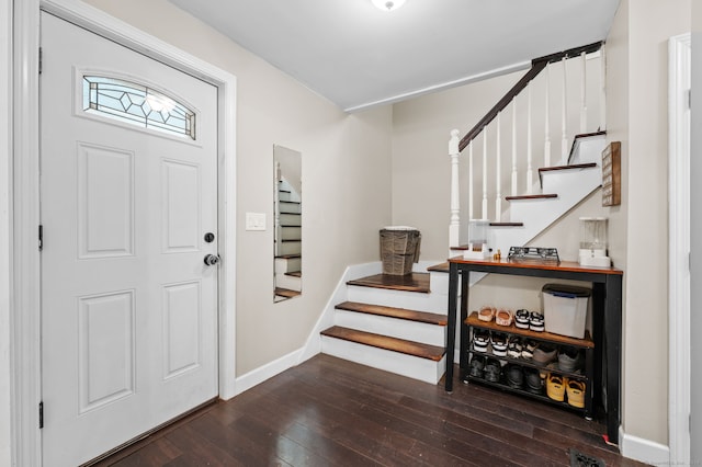 foyer entrance with stairway, baseboards, and hardwood / wood-style floors