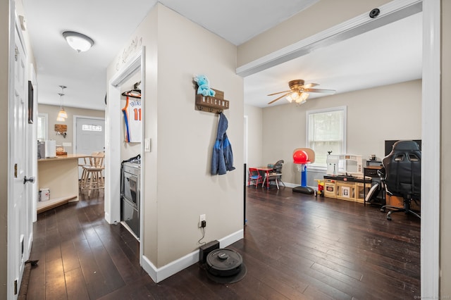 hallway featuring baseboards and dark wood-type flooring