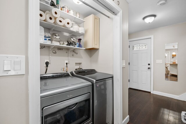 clothes washing area with washing machine and dryer, baseboards, dark wood finished floors, and cabinet space