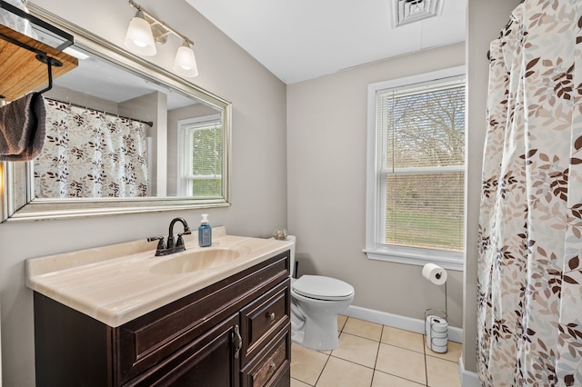 bathroom with a healthy amount of sunlight, tile patterned flooring, and visible vents