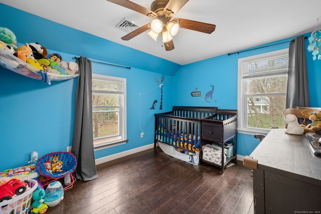 bedroom featuring ceiling fan, baseboards, wood finished floors, and visible vents