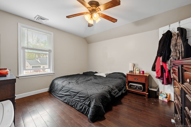 bedroom featuring hardwood / wood-style floors, vaulted ceiling, visible vents, baseboards, and ceiling fan