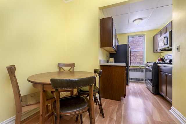 70 Strawberry Hill Ave Apt 3-2A, Stamford, CT 06902 - dining space with light wood finished floors, a paneled ceiling, and baseboards