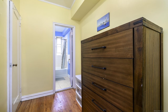 70 Strawberry Hill Ave Apt 3-2A, Stamford, CT 06902 - bedroom featuring baseboards, ornamental molding, hardwood / wood-style flooring, and connected bathroom