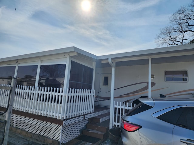 view of front of home with a sunroom