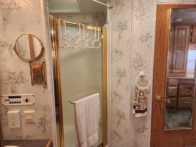 full bathroom with a stall shower and wallpapered walls