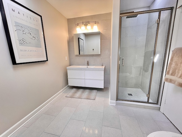 205 Arch Bridge Rd, Bethlehem, CT 06751 - bathroom with vanity, a stall shower, tile patterned flooring, baseboards, and tile walls