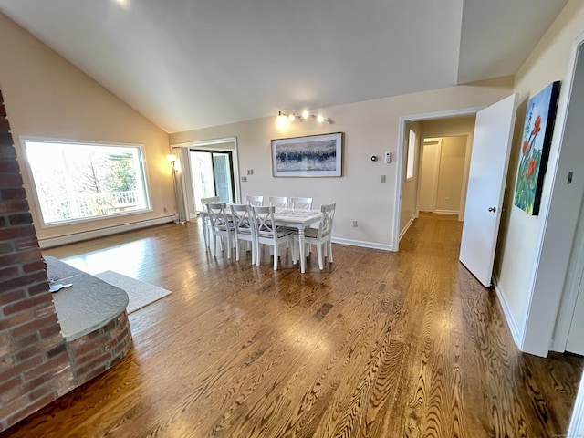 205 Arch Bridge Rd, Bethlehem, CT 06751 - dining room featuring lofted ceiling, wood finished floors, baseboard heating, and baseboards
