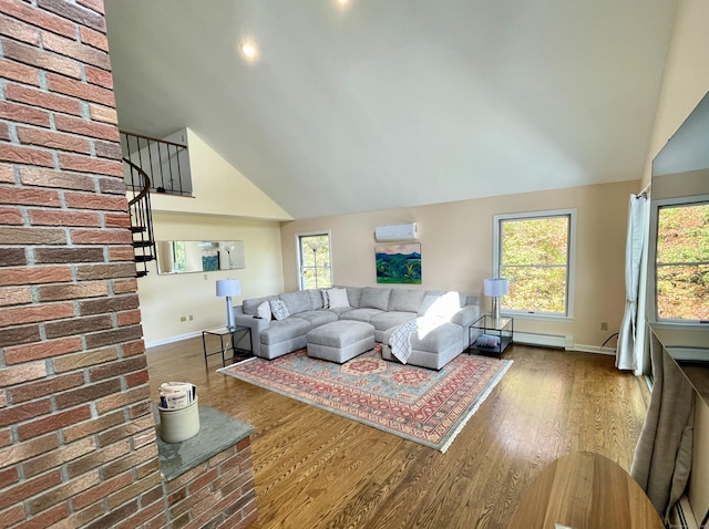 205 Arch Bridge Rd, Bethlehem, CT 06751 - living area featuring a wall mounted air conditioner, wood finished floors, lofted ceiling, stairway, and plenty of natural light