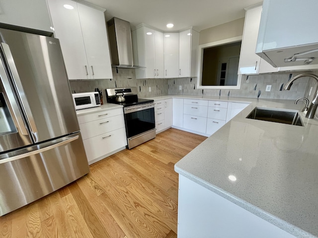 205 Arch Bridge Rd, Bethlehem, CT 06751 - kitchen with appliances with stainless steel finishes, wall chimney range hood, a sink, light wood finished floors, and tasteful backsplash