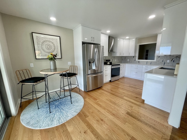 205 Arch Bridge Rd, Bethlehem, CT 06751 - kitchen with stainless steel appliances, a sink, wall chimney range hood, light wood finished floors, and backsplash