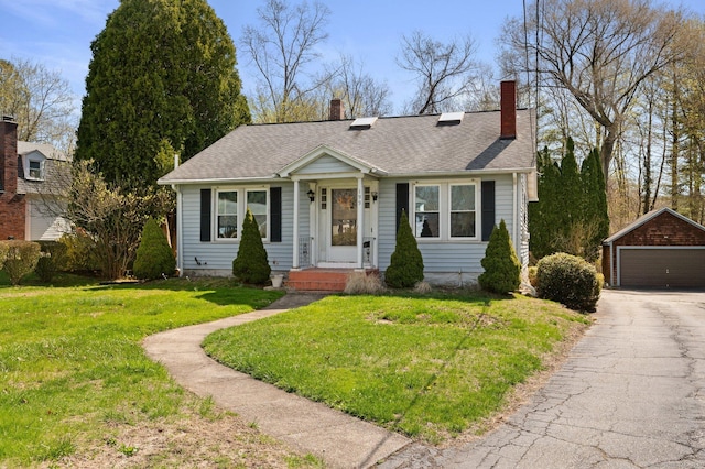 199 Harland Rd, Norwich, CT 06360 - bungalow featuring roof with shingles, an outbuilding, a garage, and a front yard
