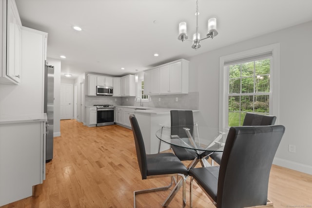 54 Edgerton Rd, Granby, CT 06090 - dining area with light wood-type flooring, a chandelier, and recessed lighting