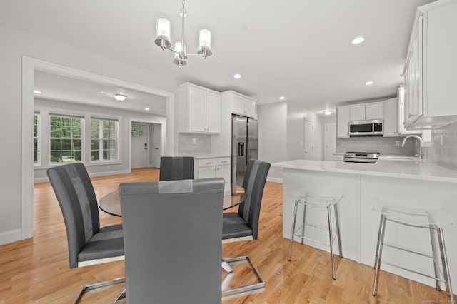 54 Edgerton Rd, Granby, CT 06090 - dining area featuring light wood-style flooring, a chandelier, and recessed lighting
