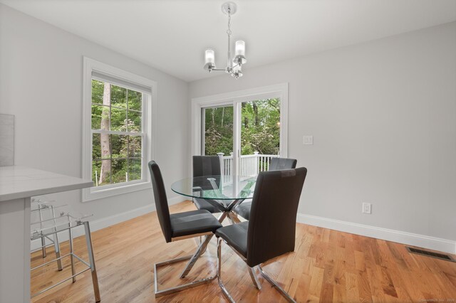 54 Edgerton Rd, Granby, CT 06090 - dining area with healthy amount of natural light, a chandelier, and light wood finished floors