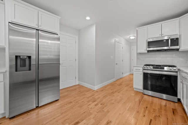 54 Edgerton Rd, Granby, CT 06090 - kitchen with stainless steel appliances, light countertops, decorative backsplash, white cabinetry, and recessed lighting